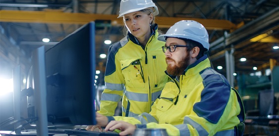 two apprenticeship students in hi-vis jackets and hard hats