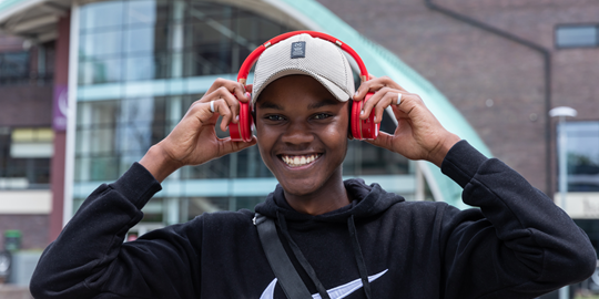 Pathway student in front of NSU building