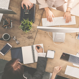 a group of people sitting at a desk