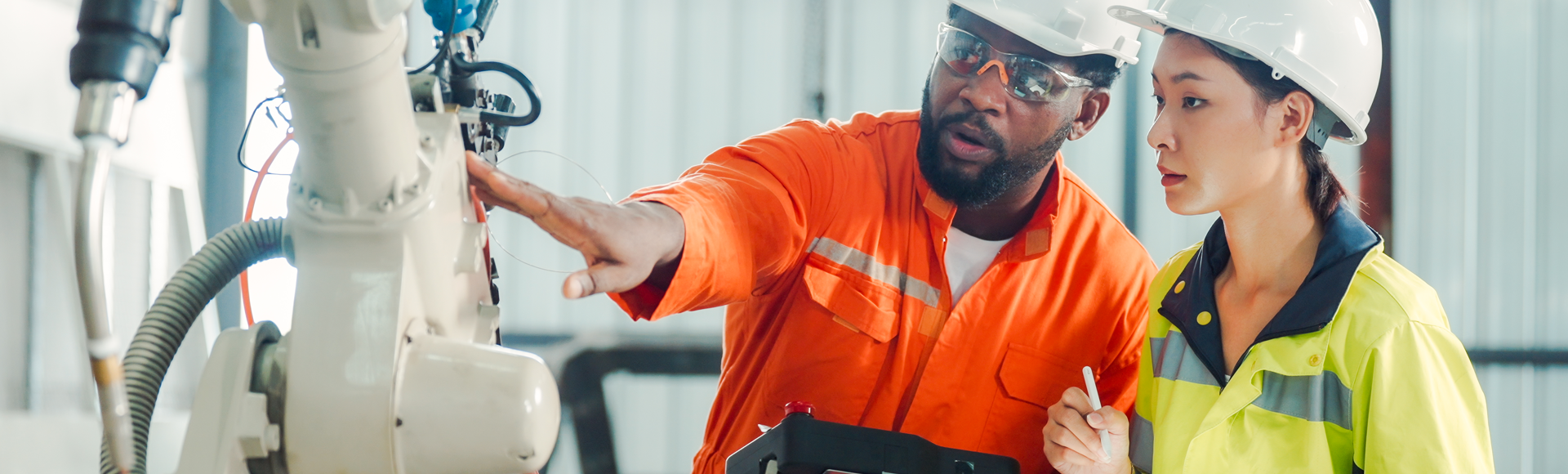 Engineering workers training and discussing robotic development 