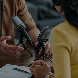 Two individuals recording a podcast