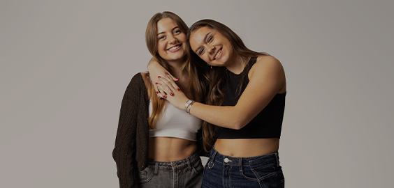 students smiling and hugging