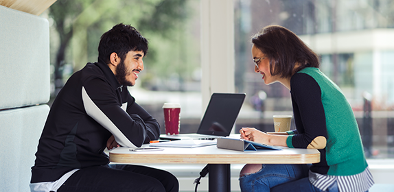 Student sat with a Career Support Advisor in Student Central, Newcastle City Campus.