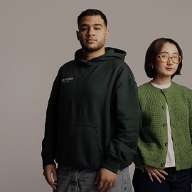A Bahrain and Indonesian student stood together, looking directly at the camera.