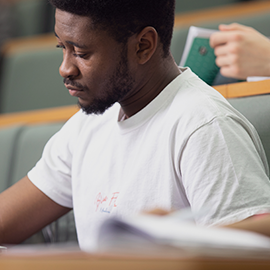 male student sitting in lecture hall