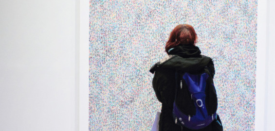 woman looking at a piece of art