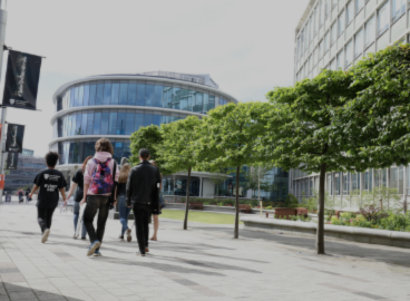 group of people walking through campus