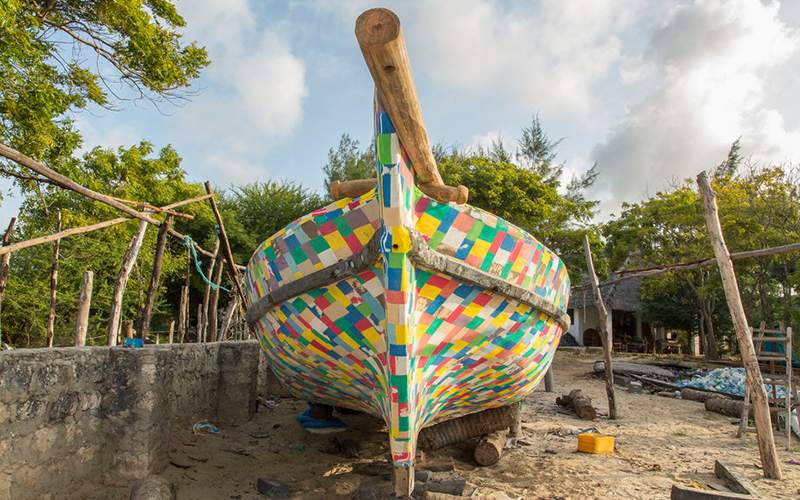 a colorful kite sitting on top of a tree
