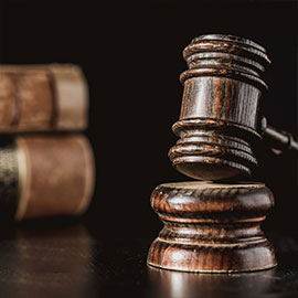 A gavel resting on a bench