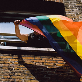 a large brick building with a colorful umbrella