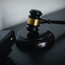 A black wooden gavel on a stand
