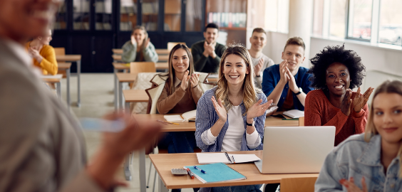 students sat in classroom clapping