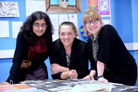 a group of people sitting at a table posing for the camera