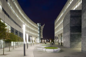 an empty road with a building in the background