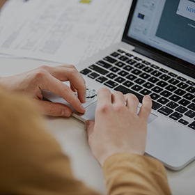 Close-up of an individual using a laptop