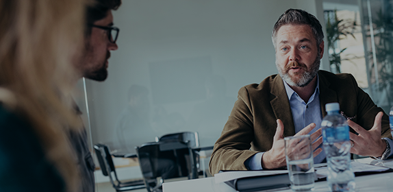 Careers advisor talking to two students