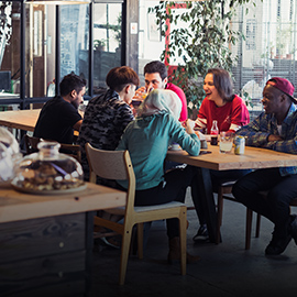 a group of people sitting at a table in a restaurant