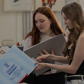 two students looking at assignment