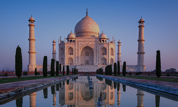 Wide-shot of Taj Mahal, India during sunrise.