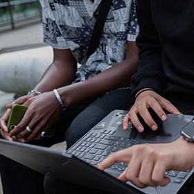 Students using a laptop.