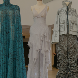 Three outfits on mannequins 