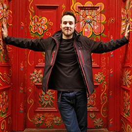 a person standing next to a painting