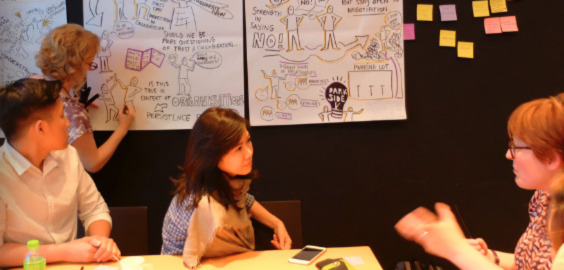 people sat at a table talking