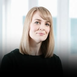 a woman standing in front of a window