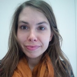 a close up of a girl smiling for the camera