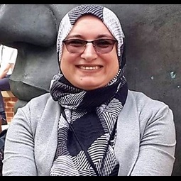 a woman wearing a hat and smiling at the camera