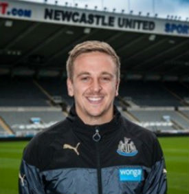a smiling man in a stadium