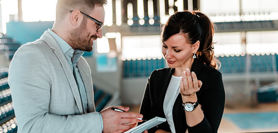 a man and a woman looking at the camera