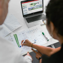 Photo of woman working on plans 