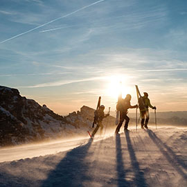 Photo of 3 people walking in the snow