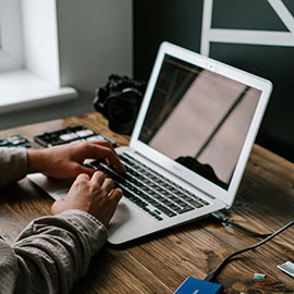 Photo of someone typing on a laptop