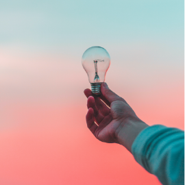 Photo showing hand holding a lightbulb