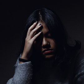 Image of woman resting her hand on her head