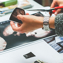Image showing person cutting a photo using scissors