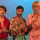 Photo showing three men in brightly coloured shirts