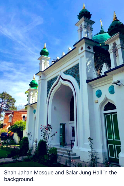 a group of people walking in front of a building