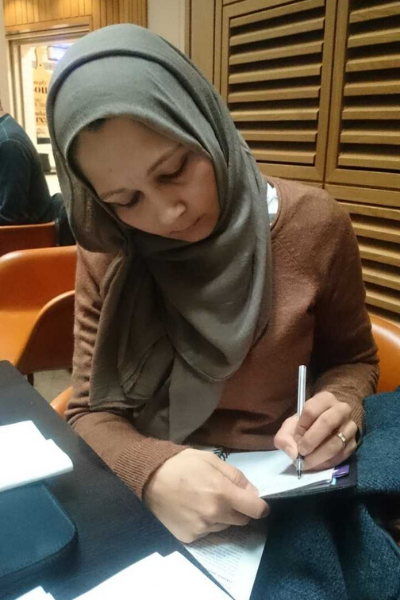 a person sitting at a table using a laptop