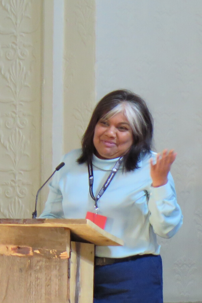 a woman standing in front of a wall