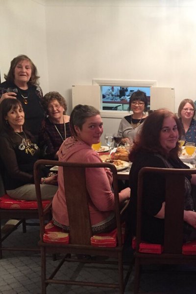 a group of people sitting at a table posing for the camera
