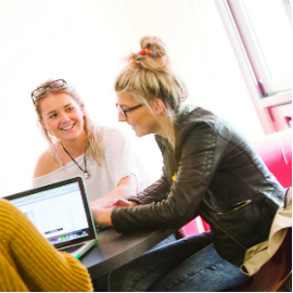a group of people sitting at a desk
