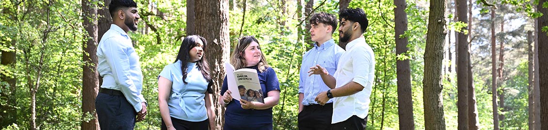 group of students talking in the woods