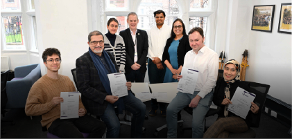 group of people holding pieces of paper up