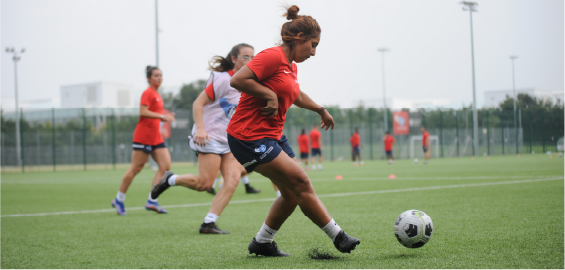 woman kicking football