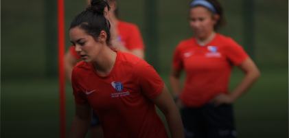 woman kicking football