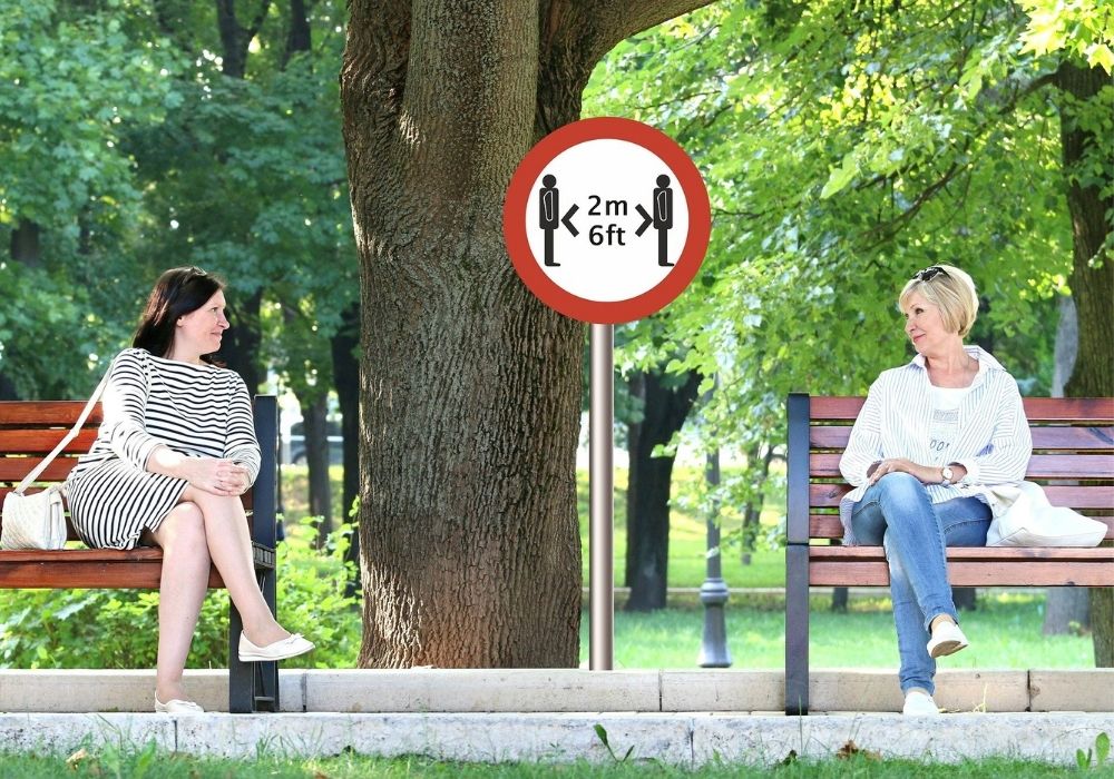 a person sitting on a bench reading a book