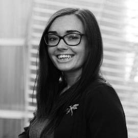 a woman standing in front of a window